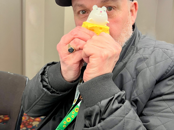 Ops manager Ross cheekily playing with a fidget toy - A squidgy piece of cheese with a mouse that pops out when the cheese is squeezed.